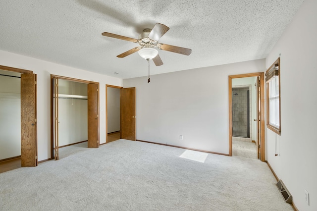 4852 S Charleston Ave, Springfield, MO 65804 - unfurnished bedroom with carpet flooring, multiple closets, a textured ceiling, ceiling fan, and baseboards