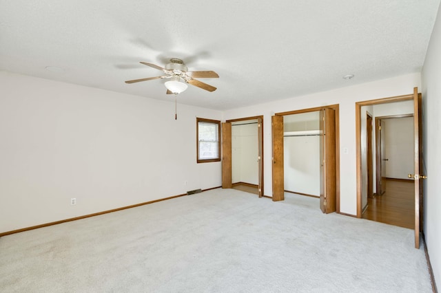 4852 S Charleston Ave, Springfield, MO 65804 - unfurnished bedroom featuring two closets, light carpet, baseboards, and ceiling fan