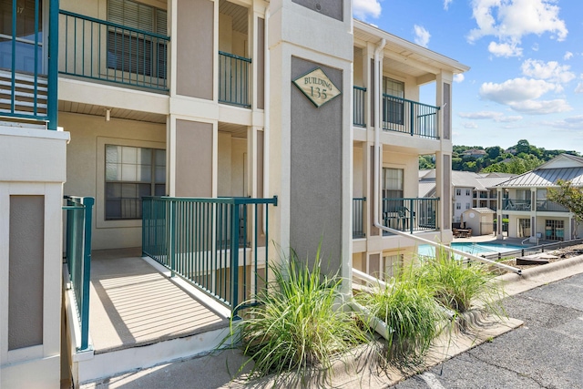 view of building exterior featuring a community pool