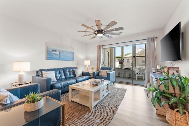 living room with ceiling fan and light wood finished floors