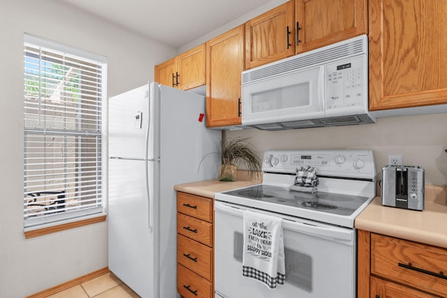 kitchen with white appliances, light countertops, and light tile patterned flooring