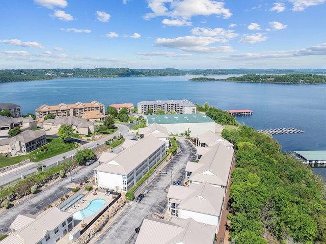 bird's eye view of a pool area and a nearby body of water