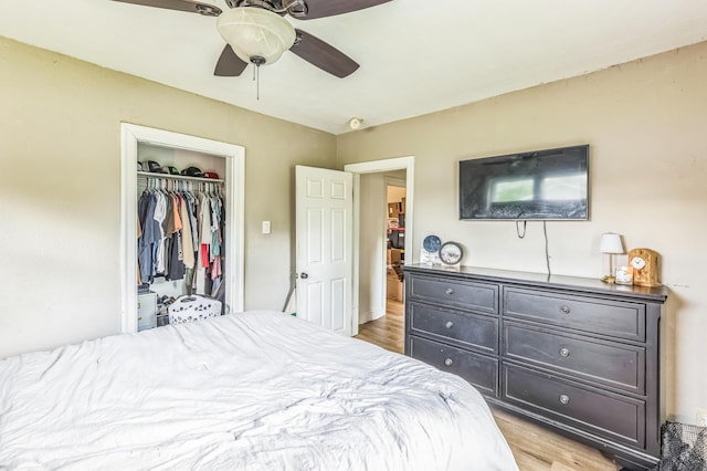 bedroom featuring light wood finished floors, a closet, and ceiling fan