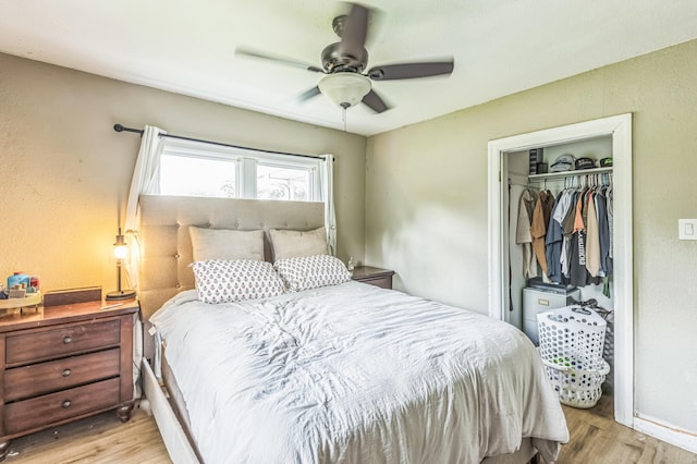 bedroom with light wood-style floors, a closet, and a ceiling fan