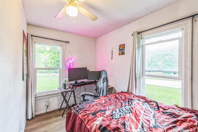 bedroom with light wood-type flooring and a ceiling fan