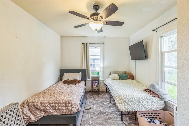 bedroom with wood finished floors and ceiling fan