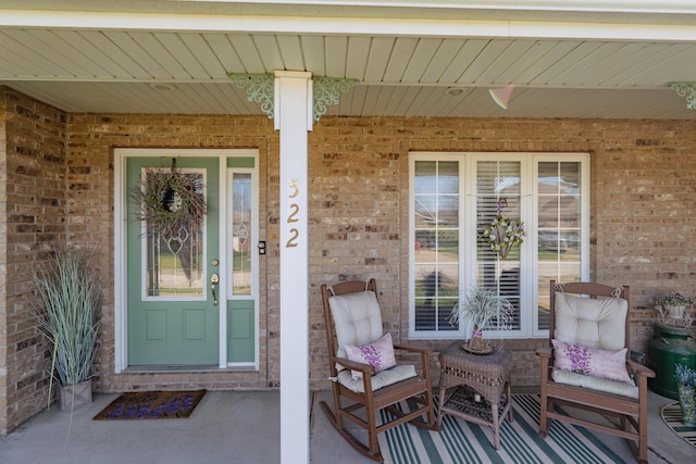522 E Grace St, Republic, MO 65738 - view of exterior entry featuring covered porch and brick siding