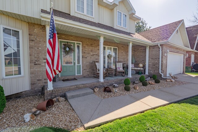 522 E Grace St, Republic, MO 65738 - view of exterior entry with covered porch, brick siding, an attached garage, and board and batten siding