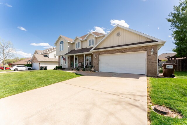 522 E Grace St, Republic, MO 65738 - traditional-style home featuring brick siding, a front yard, driveway, a garage, and covered porch