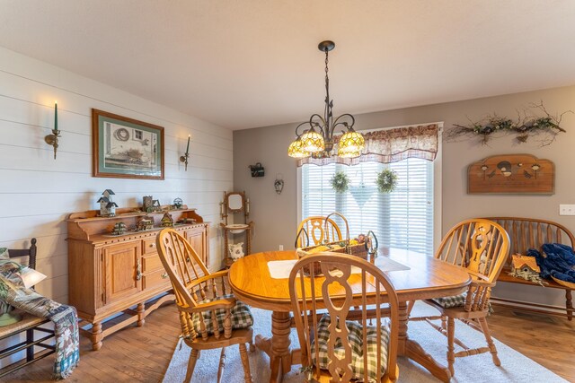 522 E Grace St, Republic, MO 65738 - dining room with a chandelier, light wood-style flooring, and wood walls