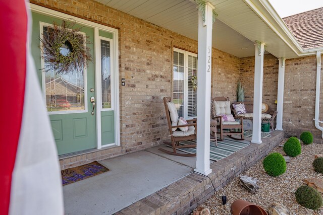 522 E Grace St, Republic, MO 65738 - doorway to property with a porch, brick siding, and a shingled roof