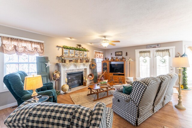 522 E Grace St, Republic, MO 65738 - living area with plenty of natural light, a ceiling fan, a tile fireplace, and wood finished floors