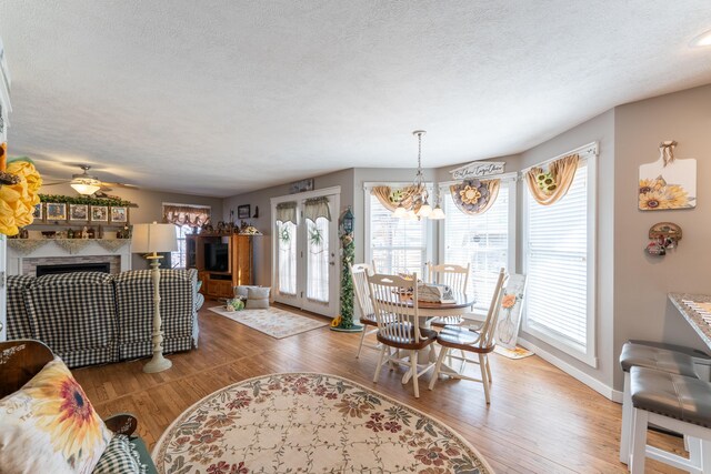 522 E Grace St, Republic, MO 65738 - living area with a textured ceiling, a fireplace, wood finished floors, baseboards, and ceiling fan