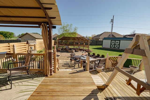 522 E Grace St, Republic, MO 65738 - wooden terrace featuring a gazebo, a storage unit, an outdoor structure, and outdoor dining area