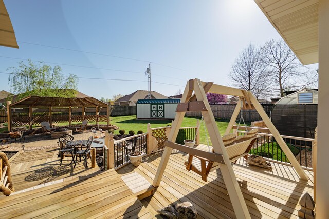 522 E Grace St, Republic, MO 65738 - wooden terrace with a playground, a pergola, an outbuilding, a storage shed, and outdoor dining area