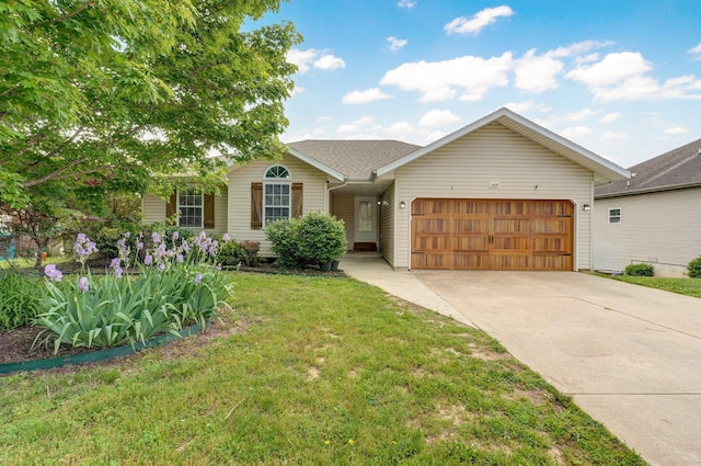 ranch-style house with a garage, driveway, and a front yard