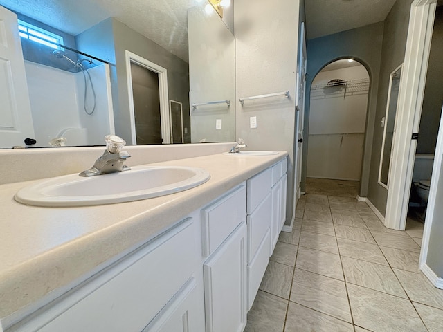 707 S Eastridge, Nixa, MO 65714 - full bath with double vanity, toilet, a walk in closet, and a shower