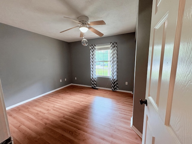 707 S Eastridge, Nixa, MO 65714 - spare room with a ceiling fan, light wood finished floors, baseboards, and a textured ceiling