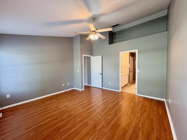 707 S Eastridge, Nixa, MO 65714 - unfurnished bedroom with baseboards, light wood-type flooring, high vaulted ceiling, a ceiling fan, and ensuite bath