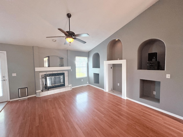 707 S Eastridge, Nixa, MO 65714 - unfurnished living room featuring a fireplace, wood finished floors, ceiling fan, baseboards, and vaulted ceiling