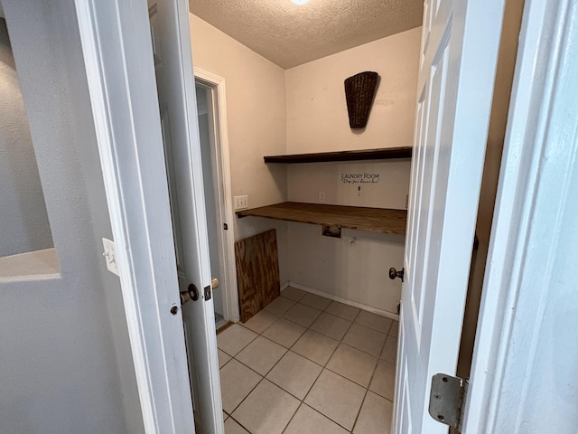 707 S Eastridge, Nixa, MO 65714 - laundry area with a textured ceiling and light tile patterned floors