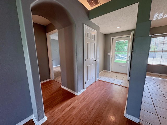 707 S Eastridge, Nixa, MO 65714 - foyer featuring baseboards, arched walkways, and light wood finished floors