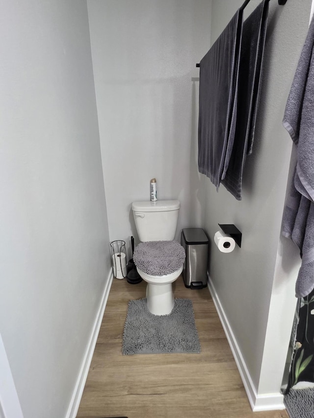 552 S Michelle Ave, Republic, MO 65738 - bathroom featuring baseboards, toilet, and wood finished floors