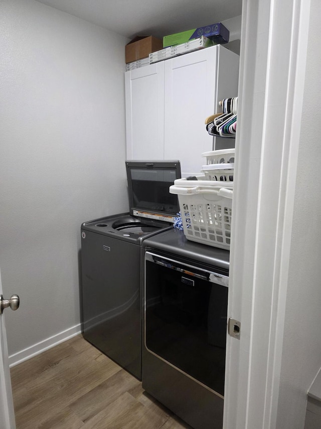 552 S Michelle Ave, Republic, MO 65738 - laundry room with washer and dryer, wood finished floors, cabinet space, and baseboards