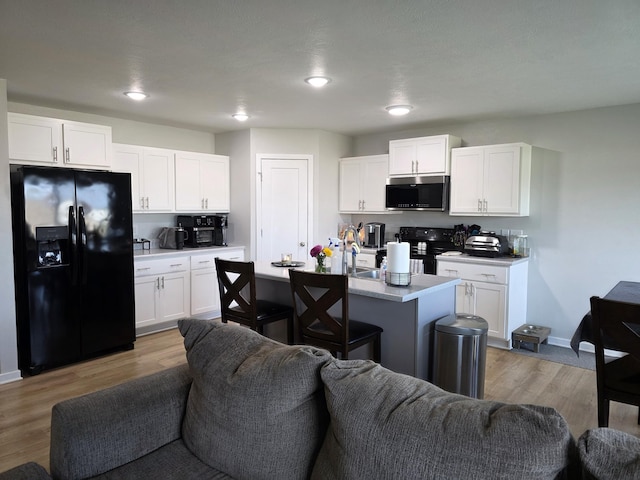 552 S Michelle Ave, Republic, MO 65738 - kitchen featuring black appliances, open floor plan, white cabinetry, light countertops, and recessed lighting