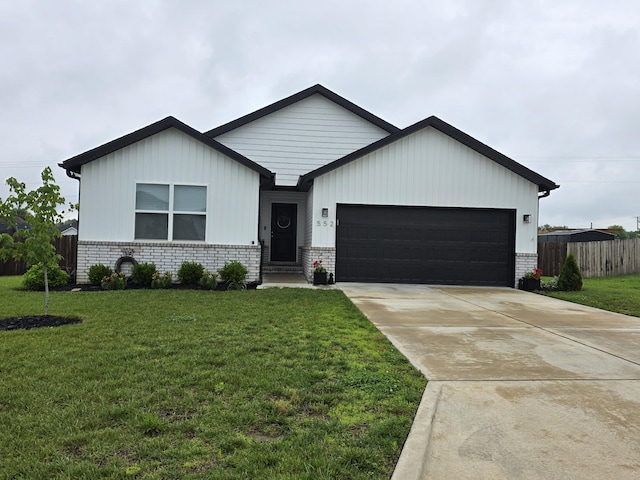 552 S Michelle Ave, Republic, MO 65738 - view of front of home with a garage, brick siding, and driveway