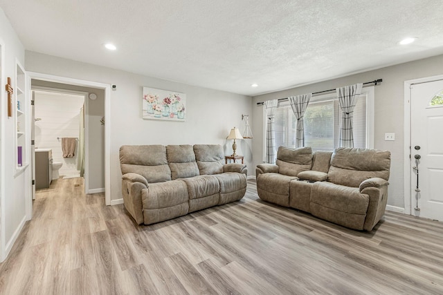 2221 W Nichols St, Springfield, MO 65802 - living room featuring light wood-style flooring, a textured ceiling, baseboards, and recessed lighting