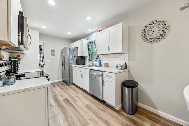 2221 W Nichols St, Springfield, MO 65802 - kitchen with stainless steel appliances, light wood-style floors, baseboards, a sink, and recessed lighting
