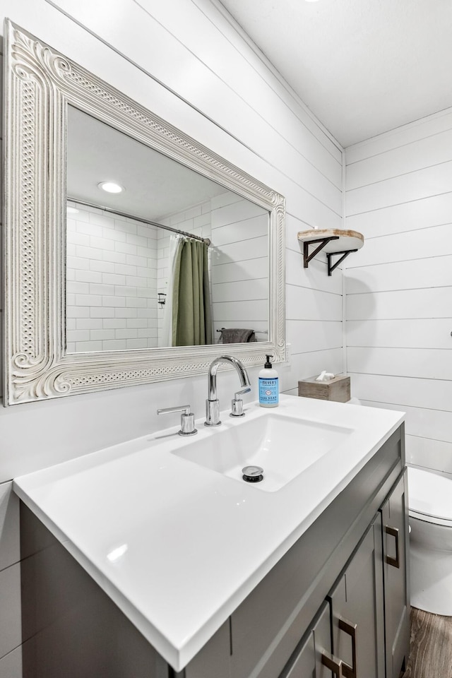 2221 W Nichols St, Springfield, MO 65802 - full bathroom with toilet, vanity, and wood finished floors