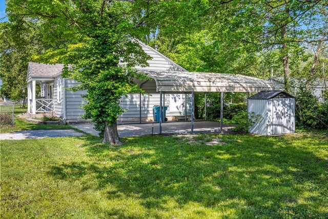 2221 W Nichols St, Springfield, MO 65802 - view of green lawn featuring a storage shed, an outbuilding, and a carport