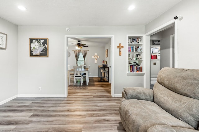 2221 W Nichols St, Springfield, MO 65802 - living area featuring light wood-style floors, recessed lighting, ceiling fan, built in features, and baseboards