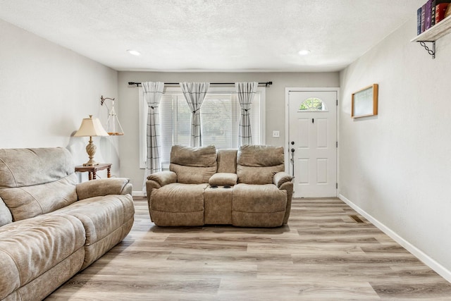 2221 W Nichols St, Springfield, MO 65802 - living area with light wood-type flooring, recessed lighting, baseboards, and a textured ceiling