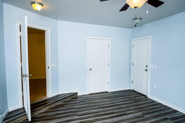 358 High Ridge Rd, Marshfield, MO 65706 - unfurnished bedroom featuring dark wood-type flooring, baseboards, and a ceiling fan