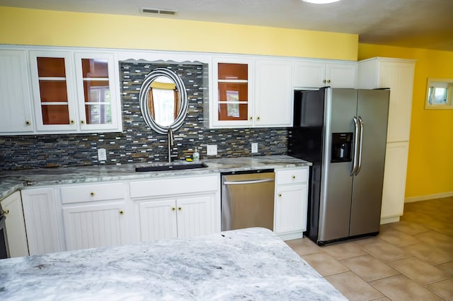 358 High Ridge Rd, Marshfield, MO 65706 - kitchen with stainless steel appliances, a sink, light tile patterned floors, and backsplash