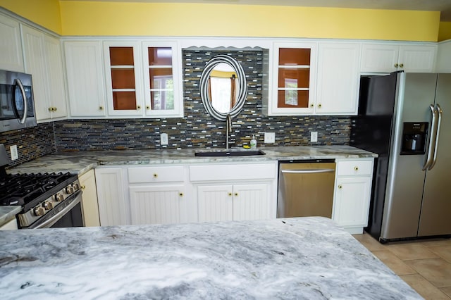 358 High Ridge Rd, Marshfield, MO 65706 - kitchen featuring appliances with stainless steel finishes, a sink, light tile patterned floors, tasteful backsplash, and light stone countertops