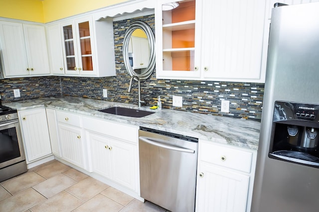 358 High Ridge Rd, Marshfield, MO 65706 - kitchen featuring appliances with stainless steel finishes, a sink, light tile patterned floors, backsplash, and white cabinetry