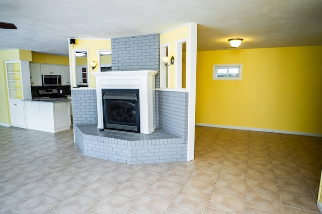 358 High Ridge Rd, Marshfield, MO 65706 - living room featuring a brick fireplace, baseboards, light tile patterned floors, and a textured ceiling