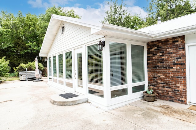 358 High Ridge Rd, Marshfield, MO 65706 - view of property exterior featuring a patio area and brick siding
