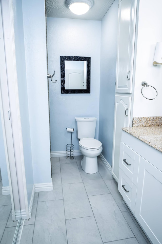 358 High Ridge Rd, Marshfield, MO 65706 - bathroom featuring vanity, toilet, and baseboards
