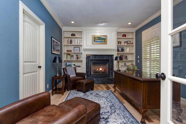 5853 S Northern Ridge Rd, Springfield, MO 65810 - living area featuring light wood finished floors, a fireplace, ornamental molding, built in shelves, and baseboards