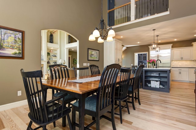 5853 S Northern Ridge Rd, Springfield, MO 65810 - dining room with light wood-style flooring, a towering ceiling, baseboards, a chandelier, and recessed lighting