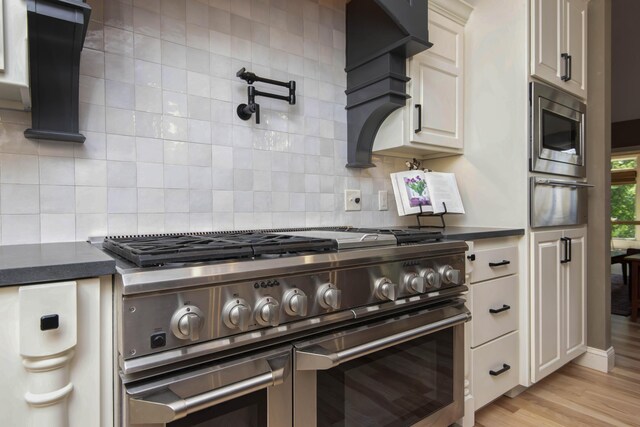 5853 S Northern Ridge Rd, Springfield, MO 65810 - kitchen featuring stainless steel appliances, dark countertops, a warming drawer, and backsplash