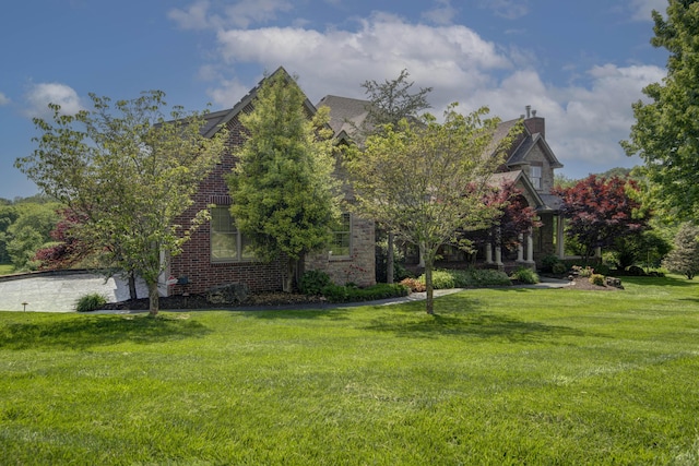 5853 S Northern Ridge Rd, Springfield, MO 65810 - view of home's exterior with a yard, brick siding, and a chimney