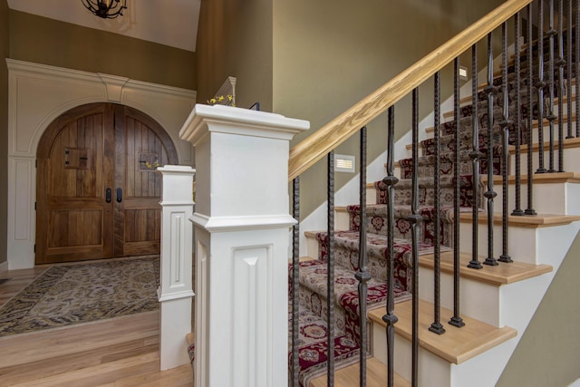 5853 S Northern Ridge Rd, Springfield, MO 65810 - wine room featuring wood finished floors, arched walkways, and a high ceiling