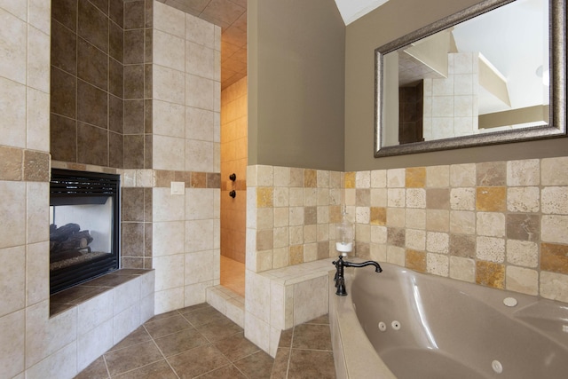5853 S Northern Ridge Rd, Springfield, MO 65810 - full bath featuring a tiled fireplace, a jetted tub, and tile patterned flooring