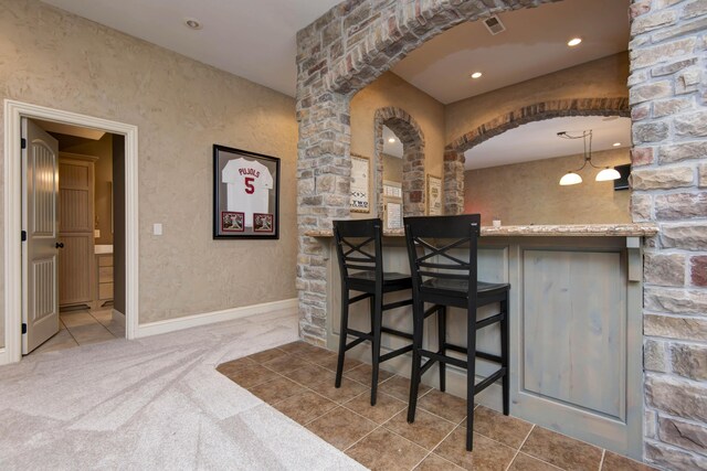 5853 S Northern Ridge Rd, Springfield, MO 65810 - bar area featuring carpet flooring, arched walkways, decorative columns, and baseboards
